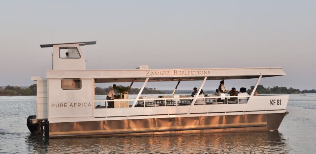 The Zambezi Reflections boat on the river in sunset, part of Pure Africa's fleet.