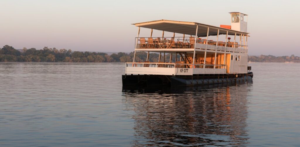 The Zambezi Breeze boat on the Zambezi River next to Pure Africa waterfront area.