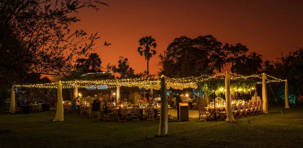 A wedding scene at the waterfront overlooking the Zambezi River during sunset.