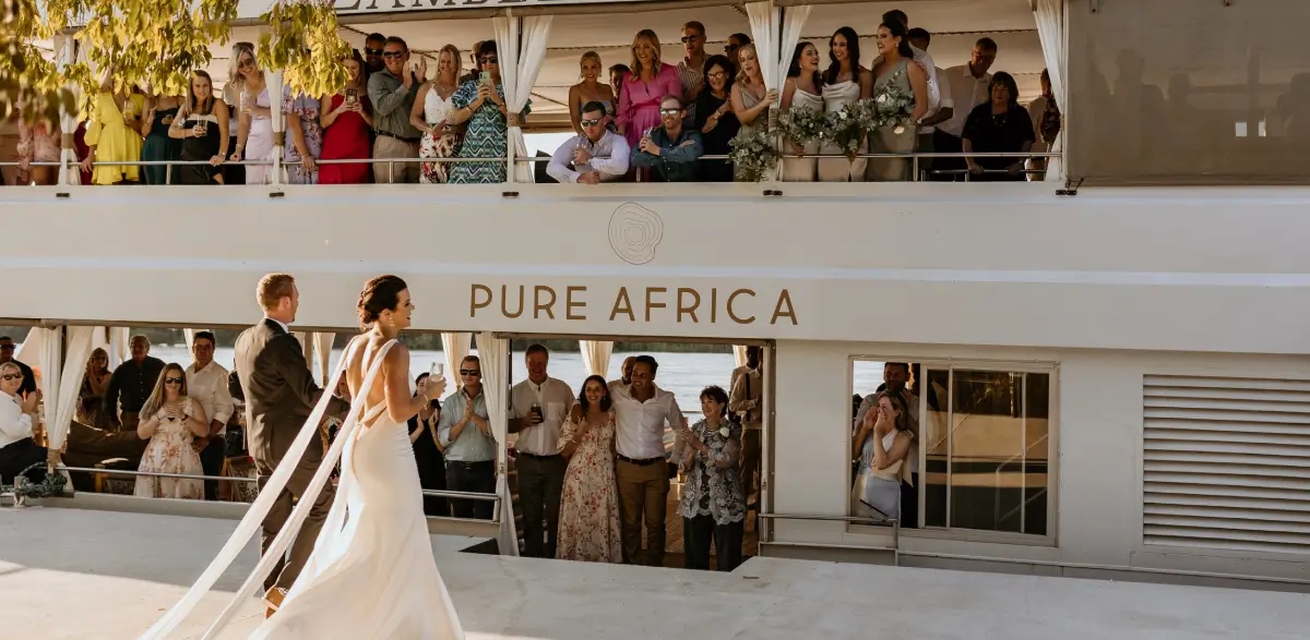 A couple boards the Pure Africa river cruise boat on their wedding day.